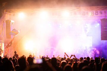 Crowd at concert and blurred stage lights.