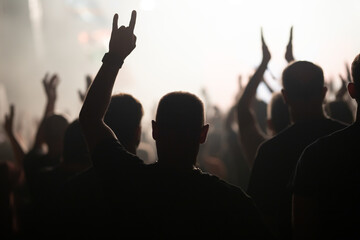Crowd at concert and blurred stage lights.