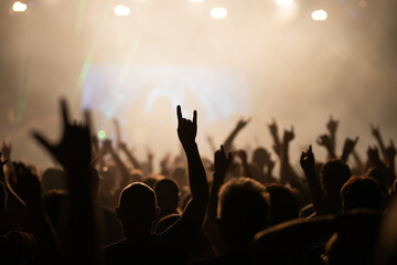 Crowd at concert and colorful stage lights.