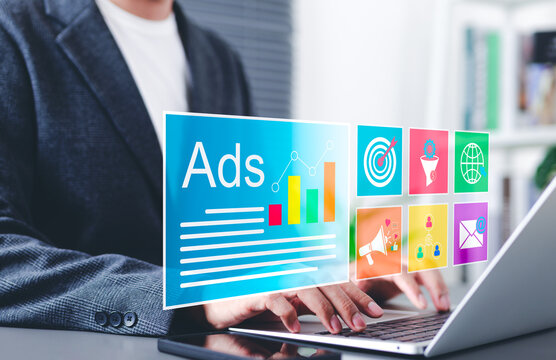Digital marketing and online advertising concept. A business professional working on laptop with interface online advertising and marketing icons, social media marketing, data analytics, ad campaigns,