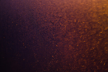 Blurred bokeh light sparkle on golden black background