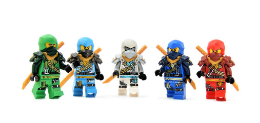 Obraz premium Editorial illustrative image of lego ninjago minifigures team of green ninja Lloyd, water ninja Nia, fire ninja Kai, Jay and Zane isolated on white.