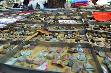 Local stall hawker beside road for thai owner selling talismans amulets and small buddha image to...