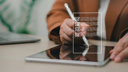 Digital document signing and online contract approval concept. User signs electronically on tablet,...