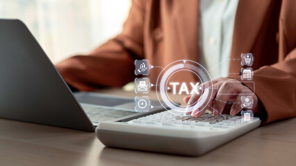 Online taxation and business financial strategy concept. Professional using a calculator and laptop for tax planning, highlighting tax reporting, compliance, corporate finance, and digital accounting.