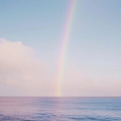 Rainbow over the sea with clouds in background