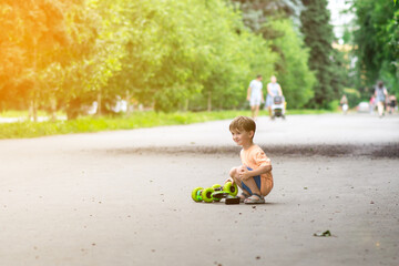 A cheerful child plays with a remote-controlled car on a sunny day in the park. His joyful expression and summer outfit highlight the fun moment.