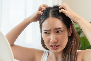 Young woman scratching her head feeling itch from dermatology problem
