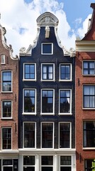 Fototapeta premium Charming Canal House Facade in Amsterdam with Ornate Gable and Windows