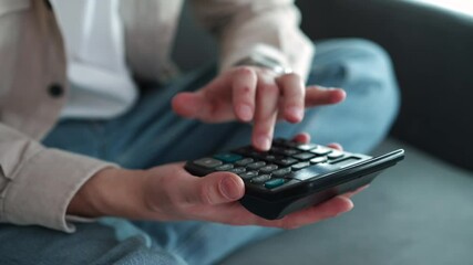 A business man in a light shirt is counting on a calculator.
A calculator is in the hands of a cashier.
A businessman is calculating profit on a calculator.
A calculator in large plans. - Powered by Adobe