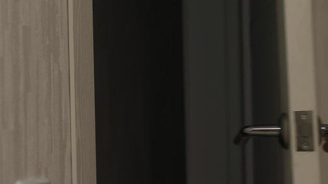 child knocking on front door, close up child's hand knocking on front door and opening by turning door handle