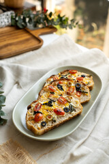 open sandwiches sourdough bread toast for breakfast or brunch with cheese tomato olives.