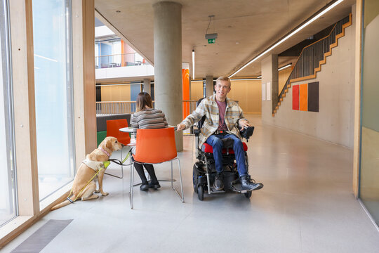 Disabled coworkers with guide dog in office