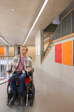 Man in wheelchair in office hallway