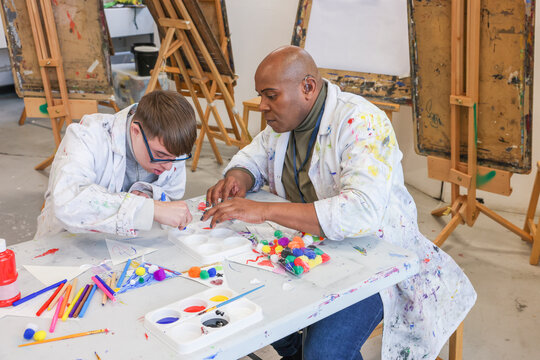 Disabled men painting in workshop