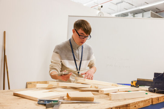 Man with Down Syndrome working in workshop