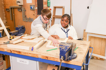 Disabled man and woman working in workshop