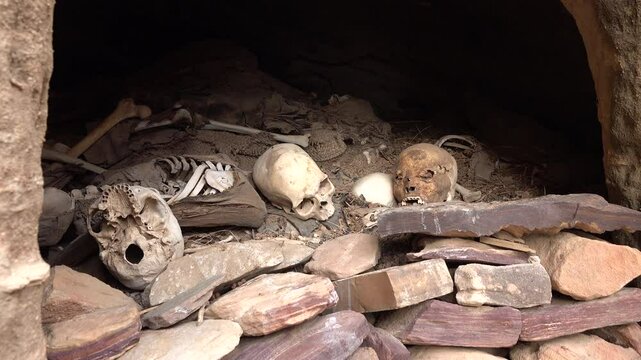Skulls, bones, and other remains of dead people in make shift graveyard near remote rock-hewn Abuna Yemata Guh church in Ethiopia, religion and culture in Africa

