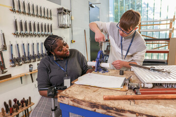 Disabled man and woman working in workshop