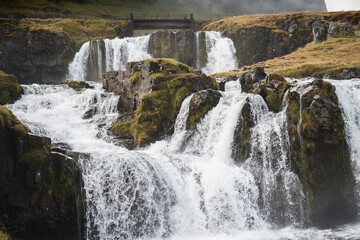 Kirkjufellsfoss waterfall cascading down mossy rocks in iceland