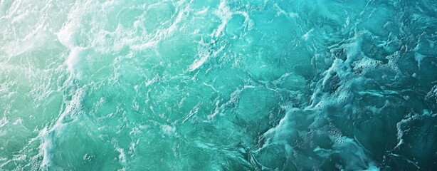 Fototapeta premium Aqua blue water with white foam texture background. Close up top view of ocean waves, turquoise sea surface
