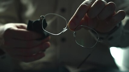 Dirty glasses.
Dust on the lenses of glasses.
Dusty glasses.
A man wipes glasses with a napkin.
A man took off his glasses and wipes them with a napkin.
Glasses, dust, glass
