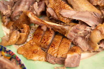 Deliciously sliced roast duck resting on a vintage plate, showcasing crispy, golden brown skin and tender meat, perfect for any meal