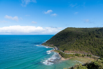 Scenic Coastal Road Along a Lush Green Hill
