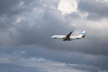 A passenger plane prepares for landing by opening its landing gear