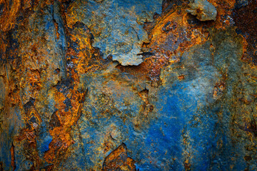 Rusty metal surface with shabby background paint. Blue cracked paint texture on an iron sheet. Fragment of an old metal door, Metal corrosion.