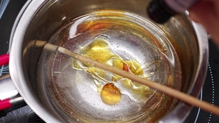 Creating aromatic candles by adding fragrance to melted gel