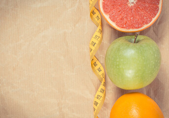 Ripe fruits and tape measure. Healthy lifestyle. Fruits as source minerals and vitamins. Place for...