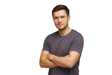 Young man with glasses poses confidently in a casual outfit against a plain background
