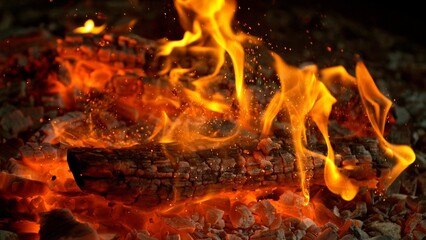 Close-up of Hot Embers with Flying Sparks . Concept of heating grills or ovens