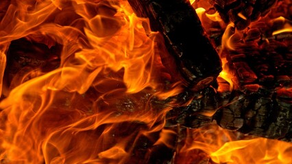 Close-up of Hot Embers with Flying Sparks . Concept of heating grills or ovens