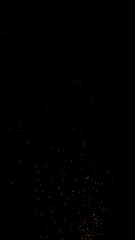 Hot sparks flying in the air isolated on black background