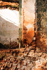 Walls of a ruined and abandoned brick building. Ruins of an old house