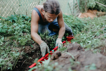 measuring the slope level of a sewer pipe in a yard