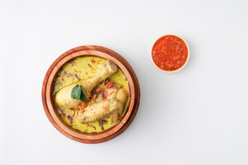 Lontong opor ayam is an Indonesian traditional dish usually served during eid Mubarak, Eid al Fitr holiday celebration with Ketupat Lebaran or rice cake dumpling and sambal chili sauce.