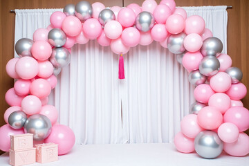 pink and silver balloon arch with a tassel