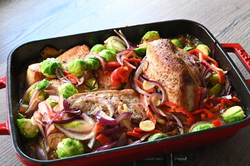 A wholesome and flavorful dish featuring oven-roasted turkey breast, crispy bacon, Brussels sprouts, red onions, and red bell peppers.