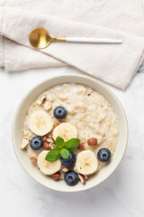 Oatmeal Bowl, Oat Porridge with Blueberry, Banana and nuts in a Bowl, Healthy Snack or Breakfast