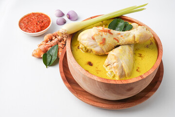 Lontong opor ayam is an Indonesian traditional dish usually served during eid Mubarak, Eid al Fitr holiday celebration with Ketupat Lebaran or rice cake dumpling and sambal chili sauce.