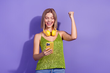 Photo of glad cute woman wear stylish sequins clothes win game isolated on purple color background