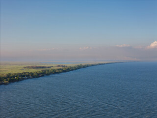 Scenic view of calm waters and lush greenery along river at sunset