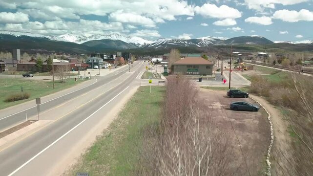 Ascending drone footage of the Fraser town, located in Grand County, Colorado, USA, on a sunny day