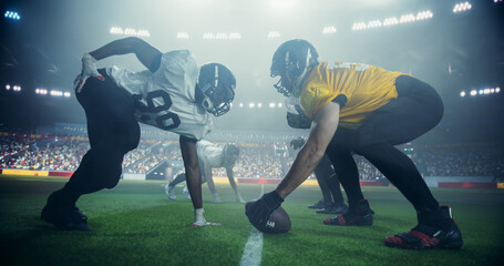 American Football Match with Players Face-off Before Action, Tackles, and Strategic Plays Start. Athletic Male Footballers Fighting for the Ball, Playing a Powerful Offensive Game