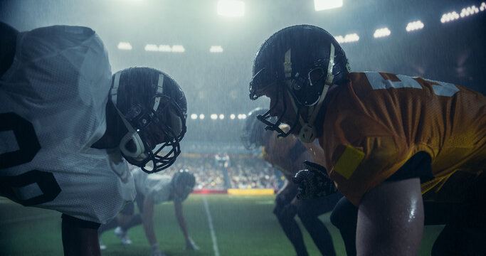 Intense Moments From An American Football Match Played Under Heavy Rain, with Gridiron Players Tackle and Execute Plays. Teams Compete on the Field in a Sports Battle for Tournament Glory
