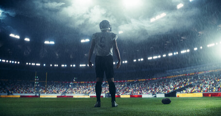 American Football Player Entering a Rainy Stadium, Inspiring Arena Crowd to Feel the Championship Sports Night Atmosphere. Athlete Walking with a Back to Camera, Preparing for the Match