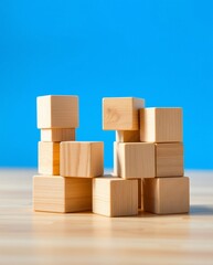 Obraz premium Stacked Wooden Building Blocks on a Bright Blue Background